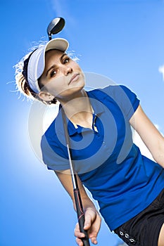 Portrait of a woman playing golf on sky