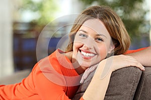 Portrait of a woman posing looking at you at home