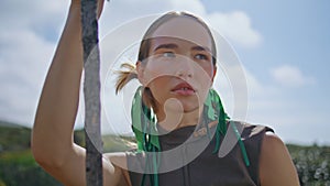 Portrait woman posing sky on mountain trip. Determined traveler resting hill