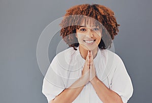 Portrait of woman with praying hands  on studio background for hope, asking please or help for opportunity