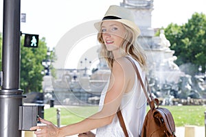 portrait woman pressing pedestrial button