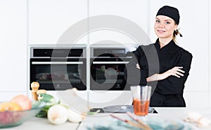 Portrait of the woman proffesional who is posing in the kitchen