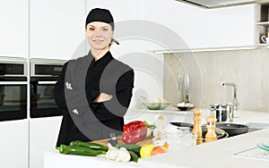 Portrait of the woman proffesional who is posing in the kitchen