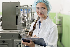 Portrait of woman quality inspector during work in cosmetics factory