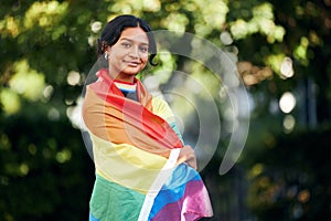 Portrait, woman and rainbow flag for pride, support and lgbtq awareness, sexuality freedom and queer. Female, girl and