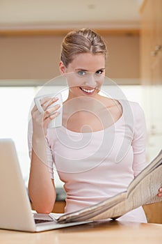 Portrait of a woman reading a newspaper