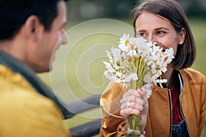 Portrait of a woman receiving a bouquet of flowers; Inlove couple concept