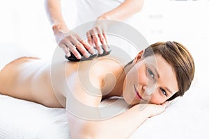 Portrait of woman receiving hot stone massage