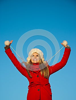 Portrait of woman in red coat blue backgound