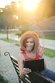 Portrait of a woman in red t-shirt with laptop in the city