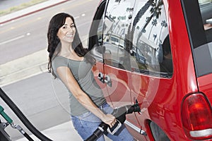 Portrait Of A Woman Refueling Her Car