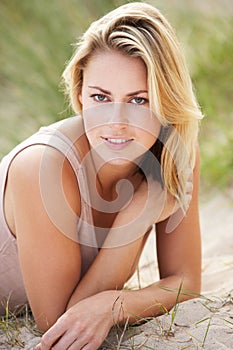 Portrait of woman relaxing on beach