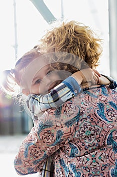 Portrait of woman reuniting with her daughter in airport