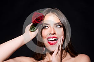 Portrait of a woman with a rose flower. Beauty fashion model woman face on a black background. Woman day concept.