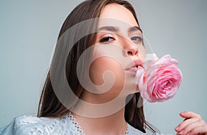 Portrait of a woman with a rose flower. Beauty fashion model woman face. Portrait with rose flowers.