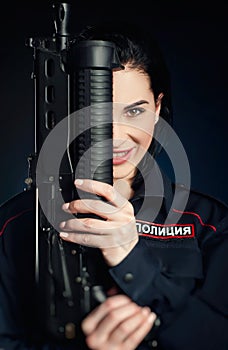 Portrait of a woman in a Russian police uniform with a rifle English translation police