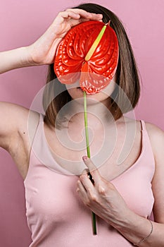 Portrait of woman`s holding red peace lilly bloom