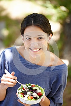 Portrait, woman and salad in outdoor for diet, nutrition and healthy eating. Green vegetables, vegan and face of happy