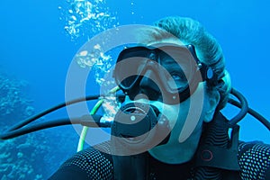 Portrait of woman scuba diver underwater