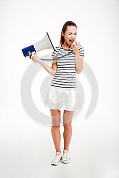 Portrait of a woman shouting in megaphone with eyes closed