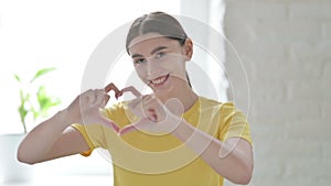 Portrait of Woman showing Heart Shape by Hands