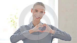 Portrait of Woman showing Heart Shape by Hands