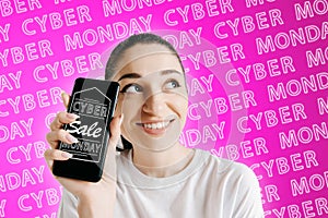 Portrait of woman showing screen of mobile phone, black friday