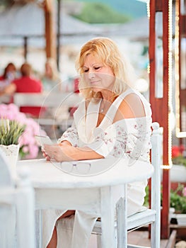 Portrait of woman sitting at beach cafe