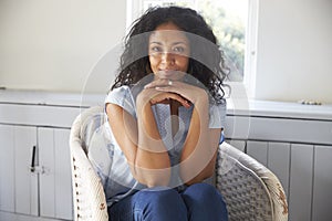 Portrait Of Woman Sitting In Chair At Home