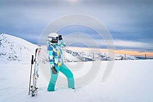 Portrait of a woman skier looking ahead on ski piste in snowy Pyrenees Mountains, Andorra