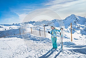 Portrait of a woman skier showing OK sign on the top of the snowy Pyrenees, Andorra