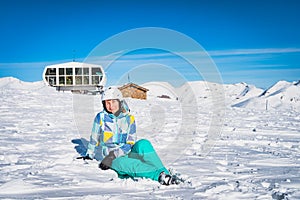 Portrait of a woman skier sitting on the snow in Pyrenees Mountains, Andorra