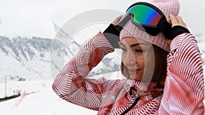 Portrait woman skier or snowboarding in the mountains