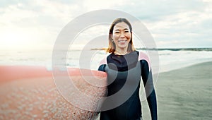 Portrait, woman and smile for surfing at beach, sea and ocean for summer holiday, travel and adventure. Happy Japanese