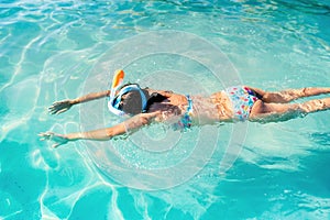 Portrait of woman with snorkeling mask dive underwater with tropical fishes in coral reef sea pool. Adventure, lifestyle and vacat