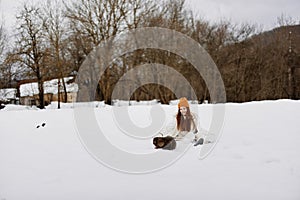 portrait of a woman in the snow playing with a dog fun friendship Lifestyle