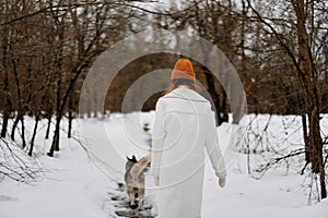 portrait of a woman in the snow playing with a dog fun friendship Lifestyle