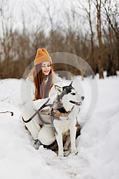 portrait of a woman in the snow playing with a dog outdoors friendship fresh air