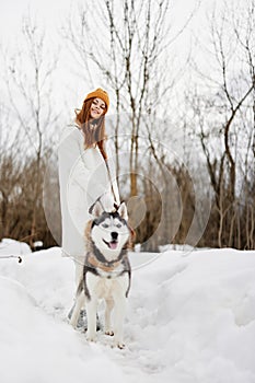 portrait of a woman in the snow playing with a dog outdoors friendship Lifestyle