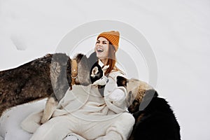 portrait of a woman in the snow playing with a dogs fun friendship fresh air