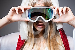 Portrait of woman snowboarder or skier in snow goggles. Girl in ski goggles.