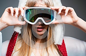 Portrait of woman snowboarder or skier in snow goggles. Girl in ski goggles.