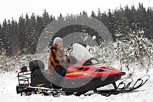 Portrait of woman on snowmobile