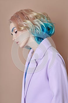 Portrait woman spring bright colored flying hair, all shades purple blue. Hair coloring, beautiful lips and makeup. Hair
