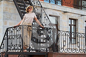 Portrait of woman standing on urban fire escape