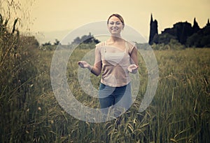 Portrait of woman standing in wheat field