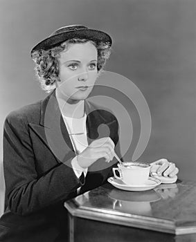 Portrait of woman stirring beverage