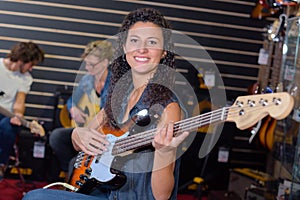 Portrait woman strumming guitar