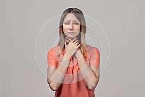 Portrait of woman suffering from cold, flu, sickness with sore throat inflammation, woman health care. Medical concept