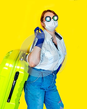 Portrait of woman in summer hat, sunglasses and medical mask on yellow background. Tourism 2020 concept.